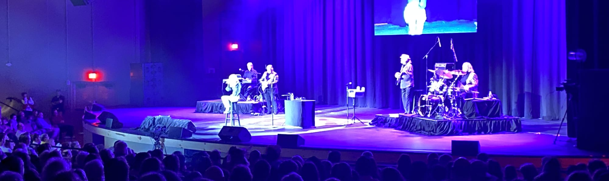 signer on stage in chair washed out by the lights San Antonio